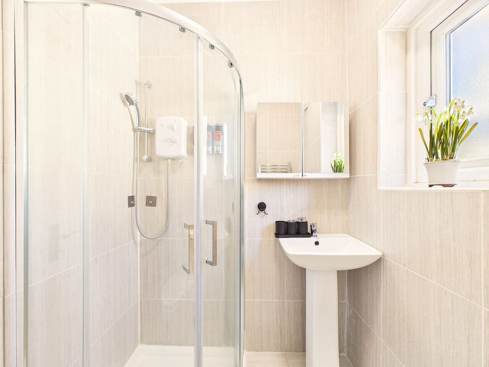 Enjoy a bright, modern bathroom featuring neutral tones and a highly functional layout.