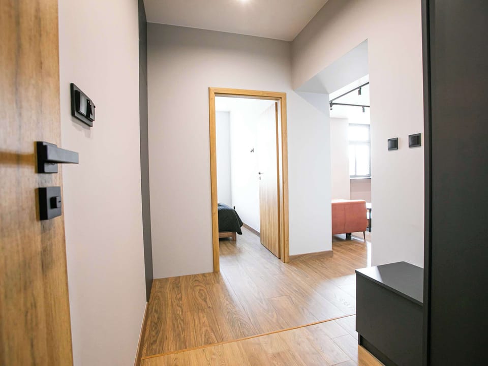 A clear look at the shower cabin with glass doors and chrome fixtures, placed next to a compact sink. The layout maximizes space while maintaining a clean and elegant appearance.