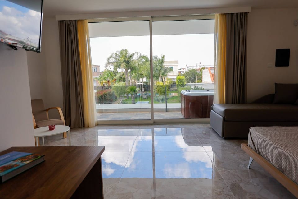 Junior Suite, Pool View | Minibar, in-room safe, desk, rollaway beds