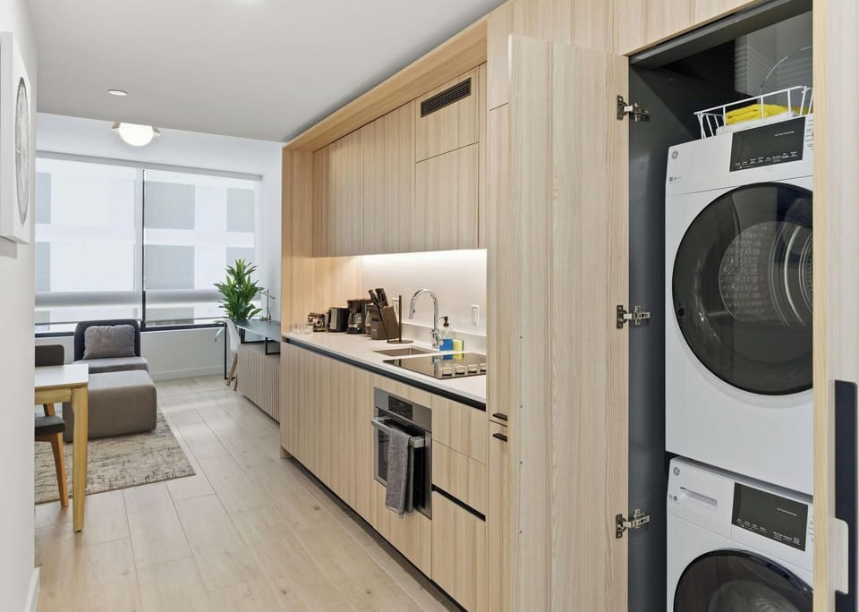 Gourmet kitchen with premium appliances and in-unit washer/dryer combo
