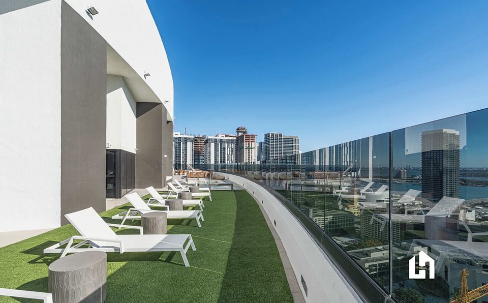 Lush rooftop terrace with turf lawn, seating & breathtaking city views
