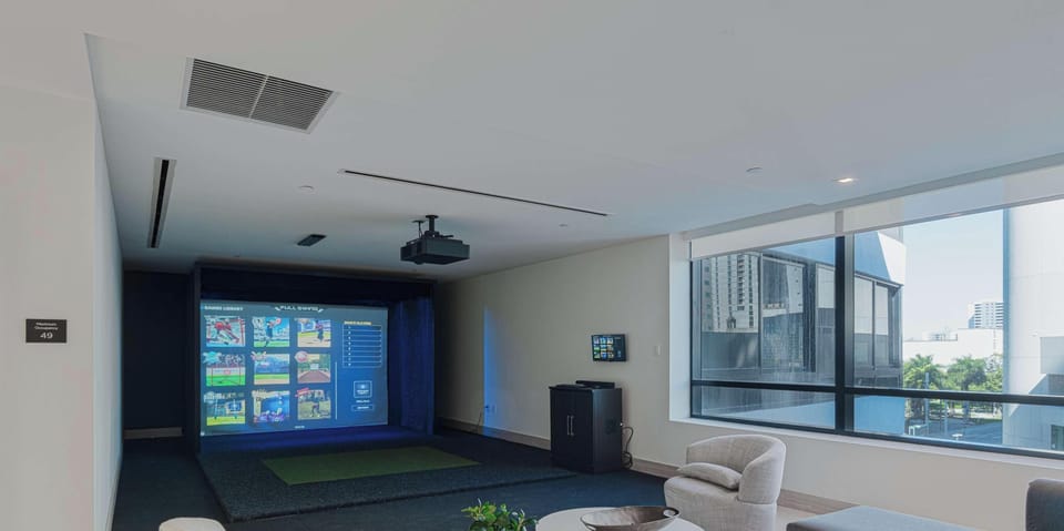 Sleek multipurpose room with built-in screens and elegant finishes