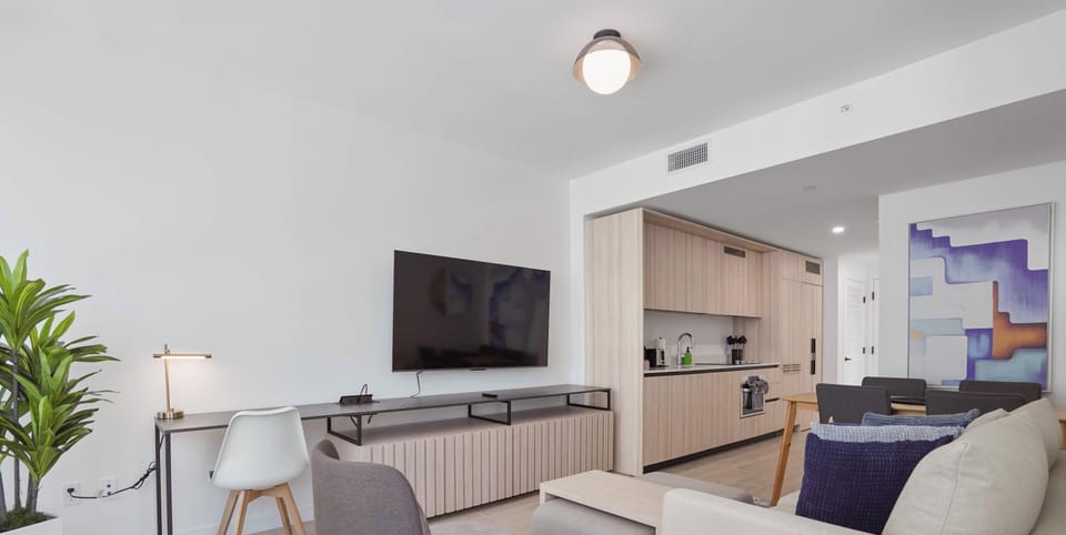 Open-concept living space with modern kitchen, sleek, bright and ready to relax in