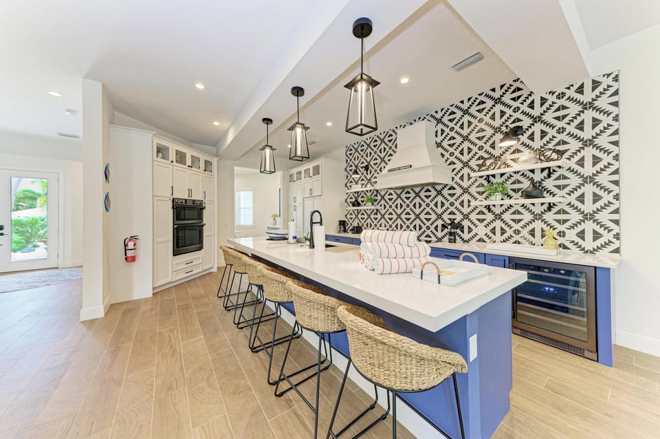 Your gourmet kitchen blends modern convenience with striking style—pendant lights illuminate the spacious island where you'll create memorable meals.