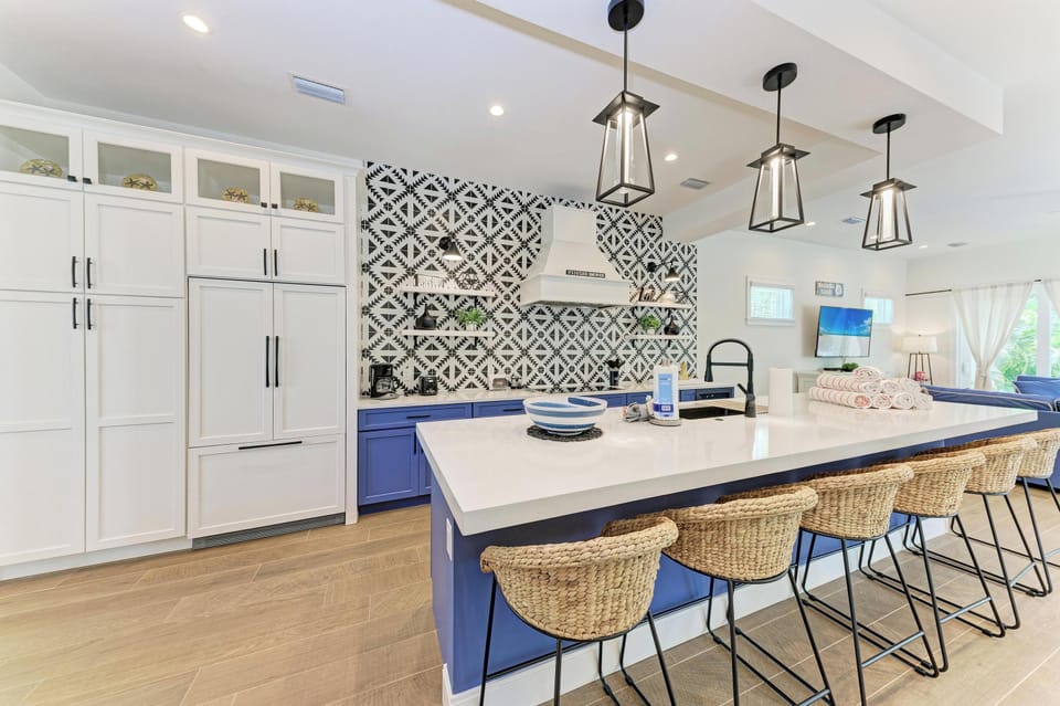 Your gourmet kitchen features a stunning island with quartz countertops, modern appliances, and stylish pendant lighting perfect for cooking together.