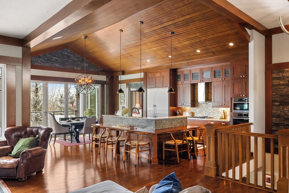 The chef's kitchen island seats four at the bar. Gas range, dual convection ovens, full-size fridge with built-in ice maker & filtered water on tap.