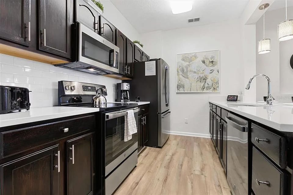 Kitchen with stainless steel appliances and quartz countertops