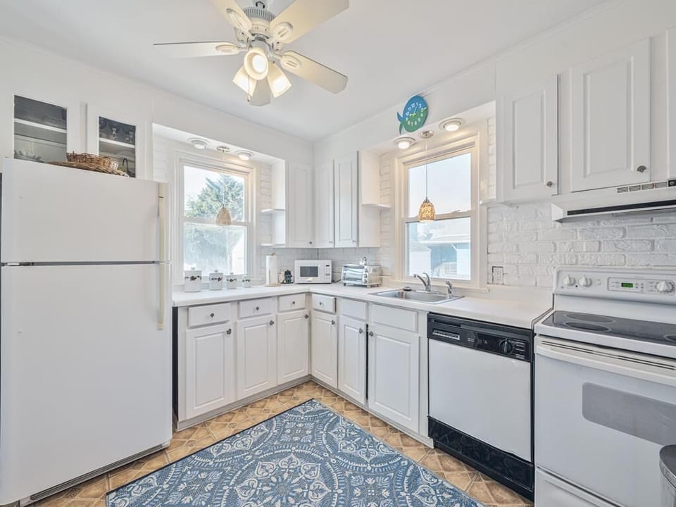 Cook up your favorite meals in this bright kitchen with ample counter space and inviting windows.