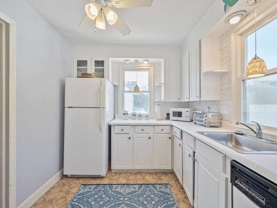 Savor morning coffee or bake your favorites surrounded by white cabinetry and cozy decor.