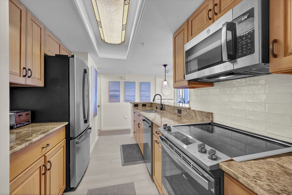 Kitchen with granite countertops and stainless steel appliances.