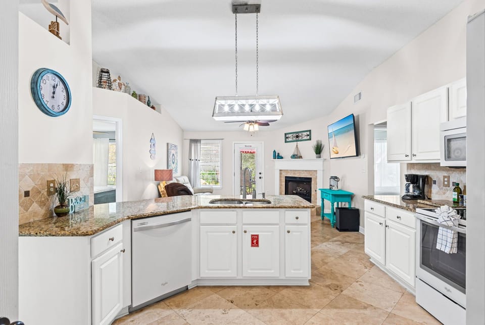 Your fully equipped kitchen features granite countertops, modern appliances, and an open layout perfect for preparing meals while staying connected to your guests.