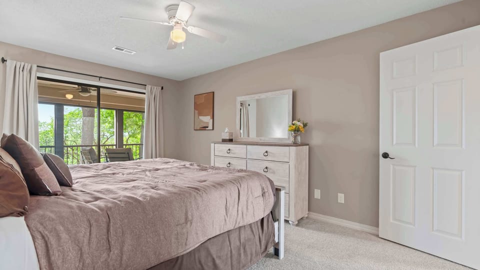 The second bedroom retreat offers deck access & a king-sized bed​
