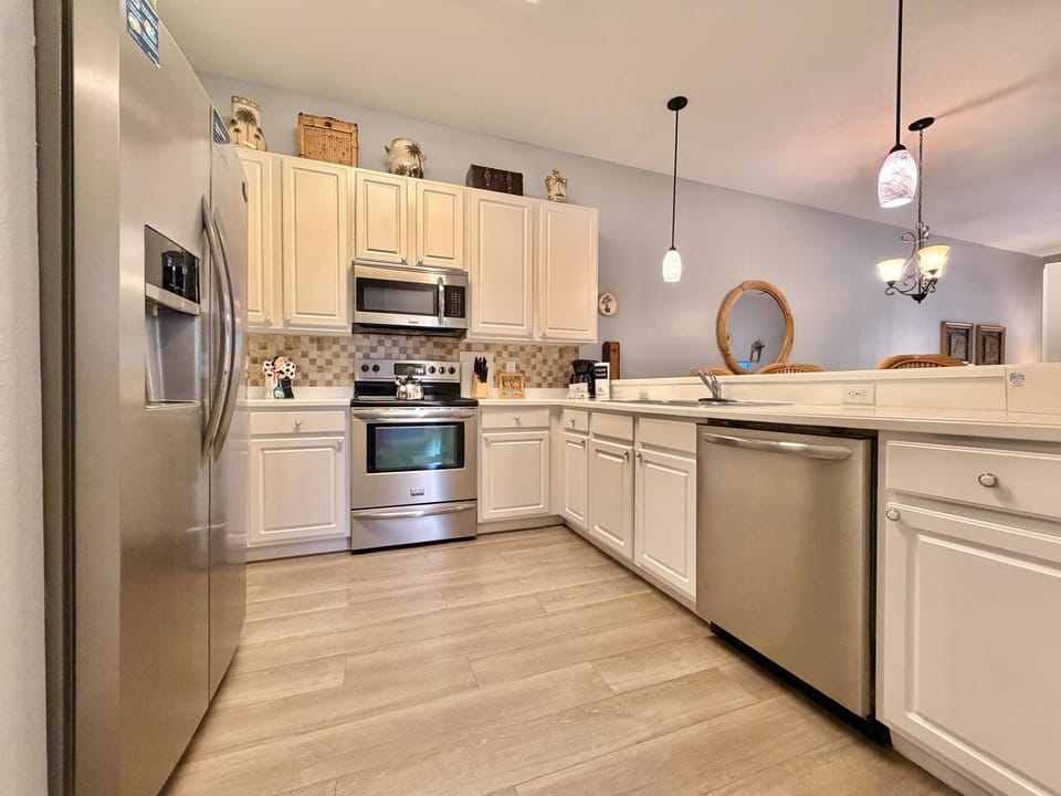 Bright, modern kitchen stocked with cookware, dishes, and essentials.
