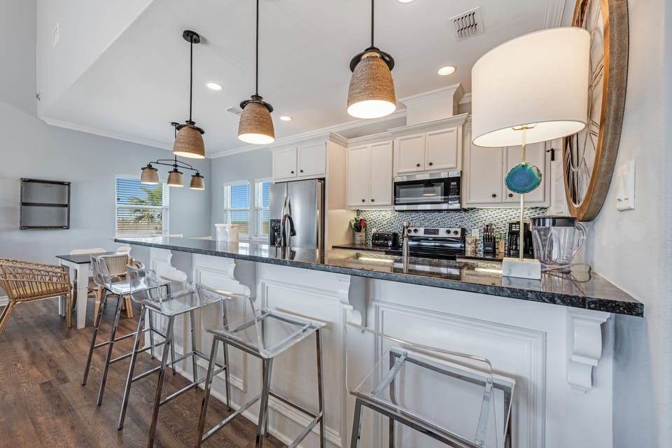 Your bright, fully-equipped kitchen invites culinary adventures with sleek granite counters, stainless steel appliances, and a spacious breakfast bar perfect for morning coffee.