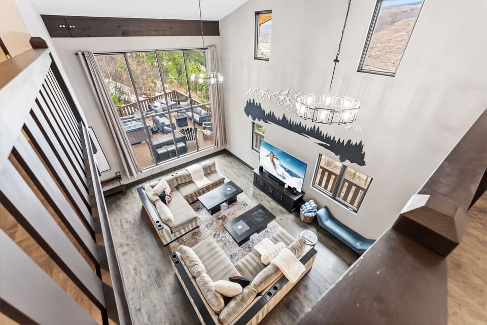 Living Room 1 [Main Floor]: mountain views,  65" Smart TV, wet bar, and gas fireplace.