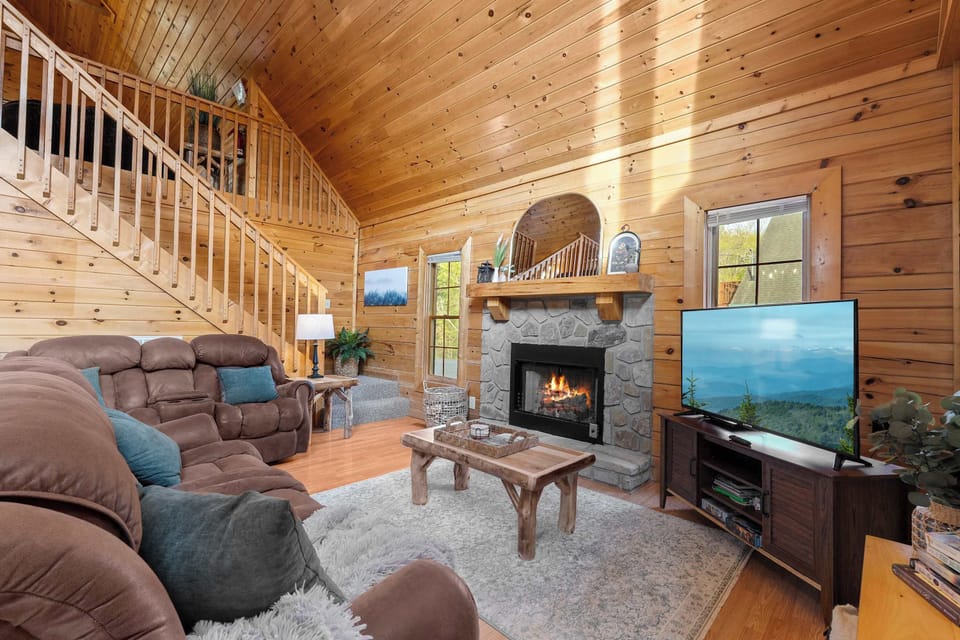 Kick your boots off and claim a recliner — fireplace crackling below the vaulted loft, everyone within earshot of each other.