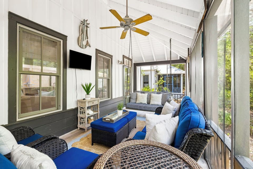 Curl up with your morning coffee on the porch swing, where high ceilings and gentle breezes create your perfect retreat for lazy afternoons.