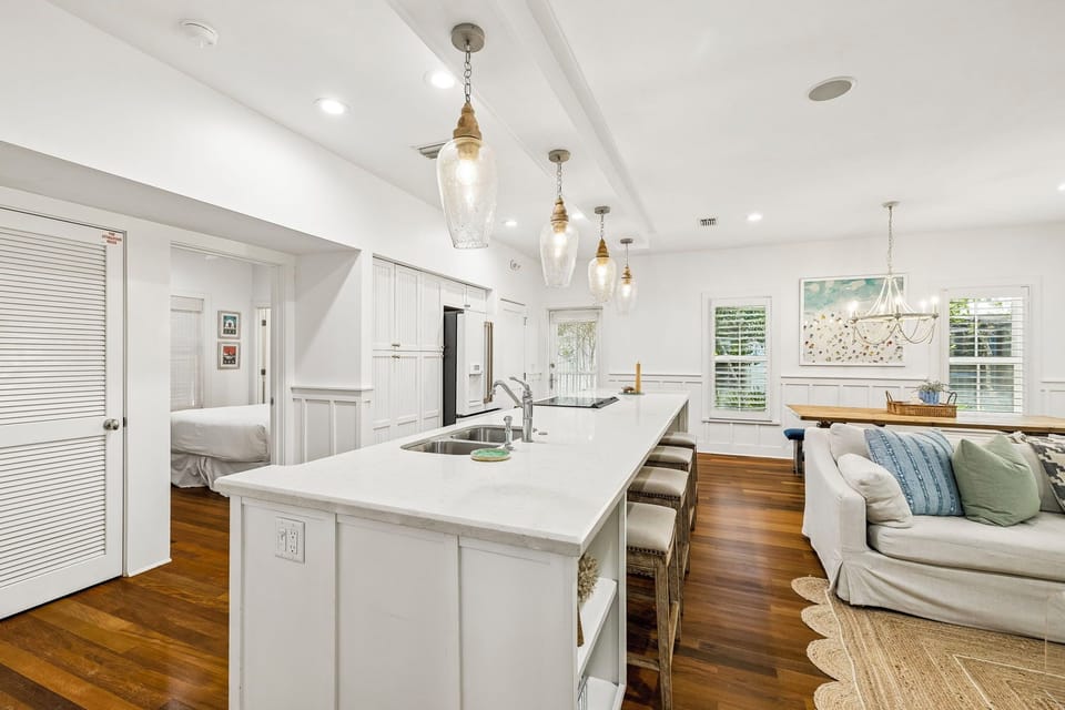 Your open-concept kitchen and living space invites you to cook, gather, and relax under warm pendant lighting and vaulted ceilings—a perfect blend of style and comfort.