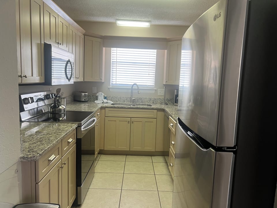 Your fully equipped kitchen features granite countertops, stainless steel appliances, and everything you need to prepare memorable meals during your stay.