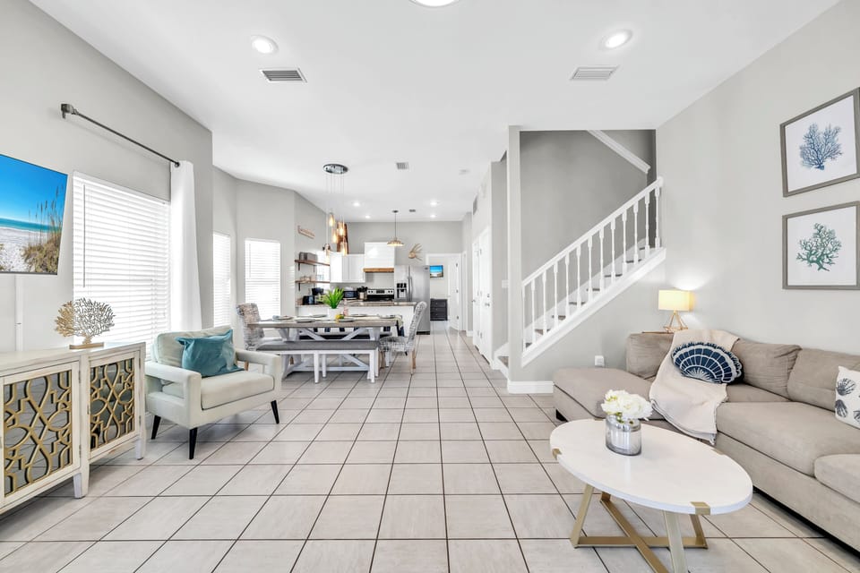 Your open-concept living space flows seamlessly from the kitchen to the living room, with coastal touches and modern comfort.