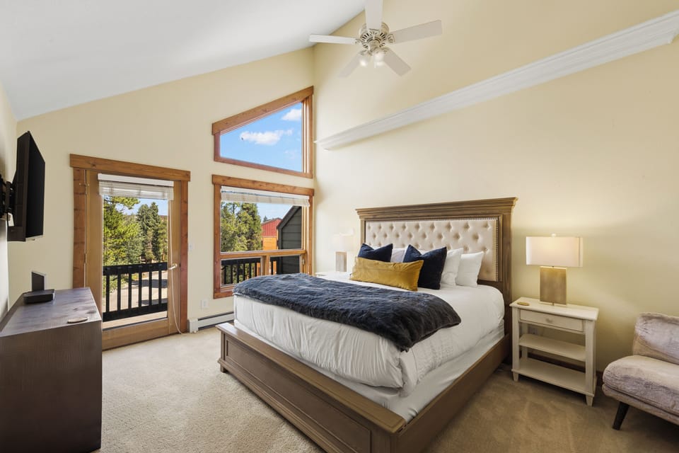 Primary/Master bedroom with King bed, private balcony and large TV