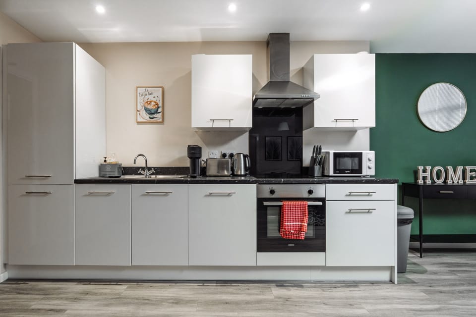 Kitchen with electric oven and hob, microwave, toaster, kettle and coffee machine