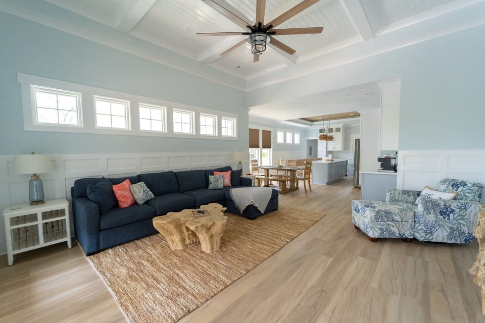 Bright open living space with vaulted ceilings and coastal charm
