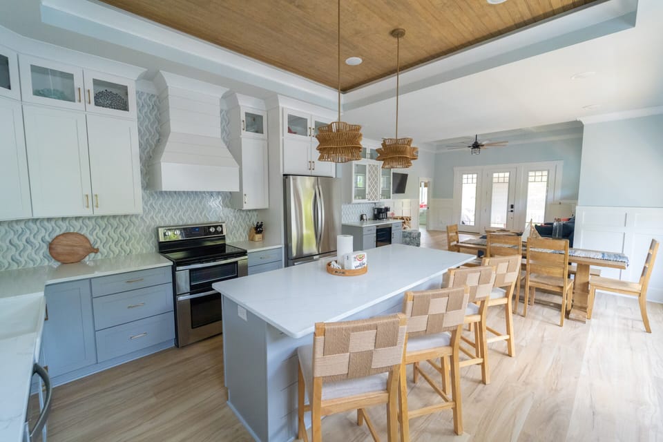 Bright coastal kitchen with large island seating and stylish open dining