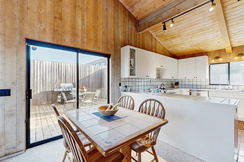 The dining area opens directly to the courtyard through sliding glass doors -- meals here feel like an extension of the outdoors.