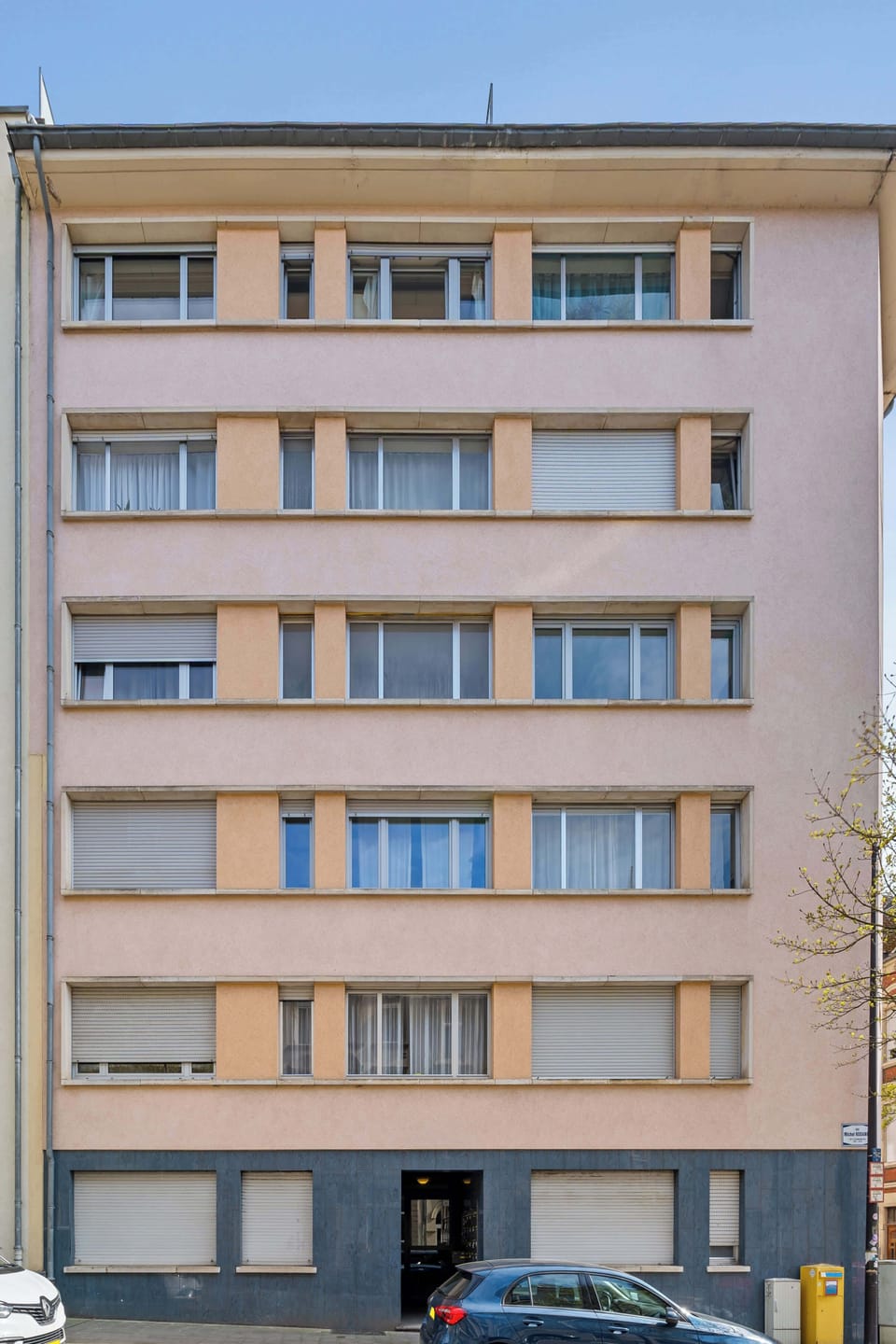 Front view of the residential building with easy access to nearby shops, restaurants, and public transport