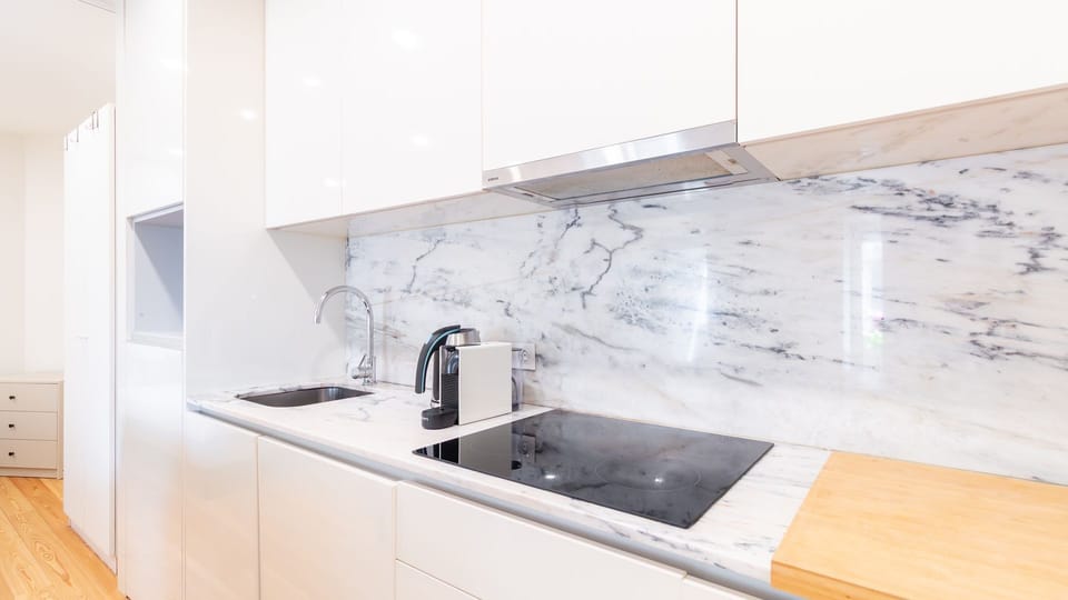 The sleek, fully equipped kitchen boasts a beautiful marble backsplash and integrated appliances, making meal preparation a stylish and effortless experience. 
#ModernKitchen #MarbleCountertop #IntegratedAppliances #CookingSpace #HomeCooking