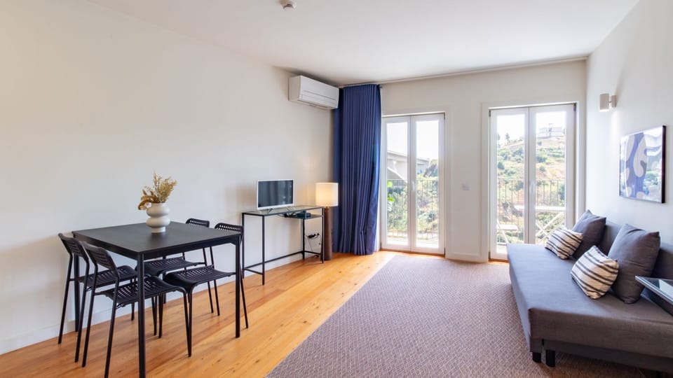 Unwind in the comfortable living area with natural light streaming through the large doors, or gather for a meal at the contemporary dining table. Enjoy seamless indoor-outdoor living with direct access to your private balcony and scenic views.