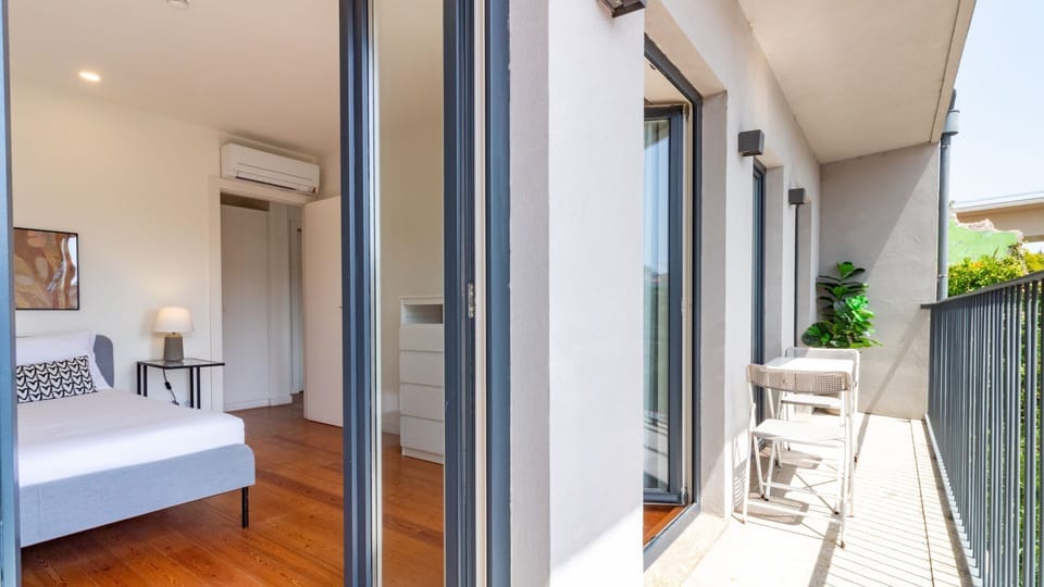 Experience seamless indoor-outdoor living with direct balcony access from this serene bedroom, allowing for refreshing breezes and picturesque views. The well-designed space connects you effortlessly to the beautiful exterior.
