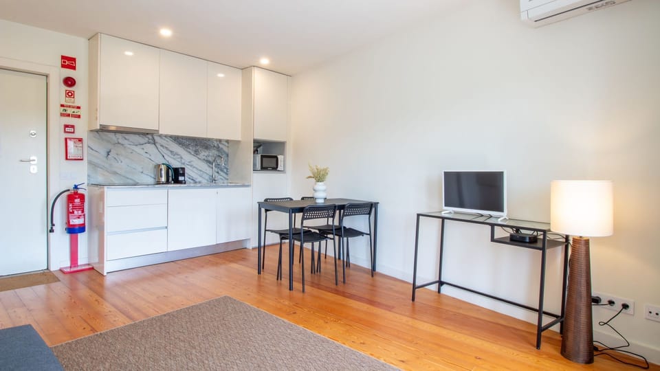 Prepare delicious meals in this sleek, fully equipped kitchen featuring modern appliances and a stylish marble backsplash, then gather around the dining table for memorable moments. The open layout ensures a social cooking and dining experience.