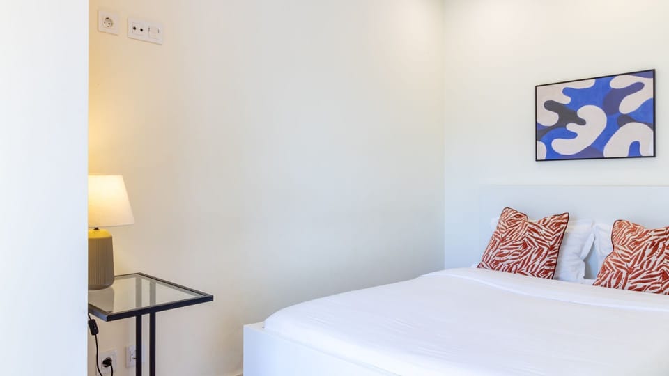 Drift off to sleep in this serene bedroom, featuring a comfortable bed with stylish accents and a soft ambient glow from the bedside lamp, perfect for restful nights. #PeacefulBedroom #ComfortableSleep #ModernDecor #AmbientLighting #RelaxingRetreat #Minim