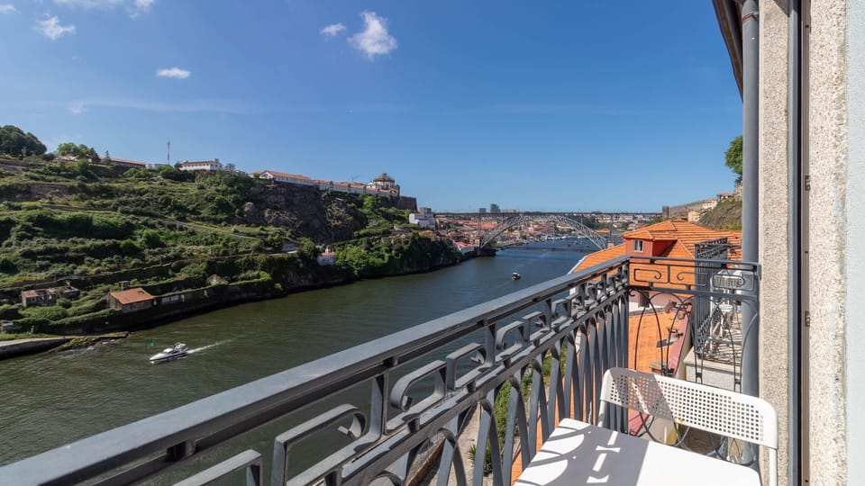 Savor your morning coffee or an evening drink on this charming balcony, offering a stunning panoramic view of the iconic bridge and the winding river below. This is your personal front-row seat to the city's picturesque landscape.