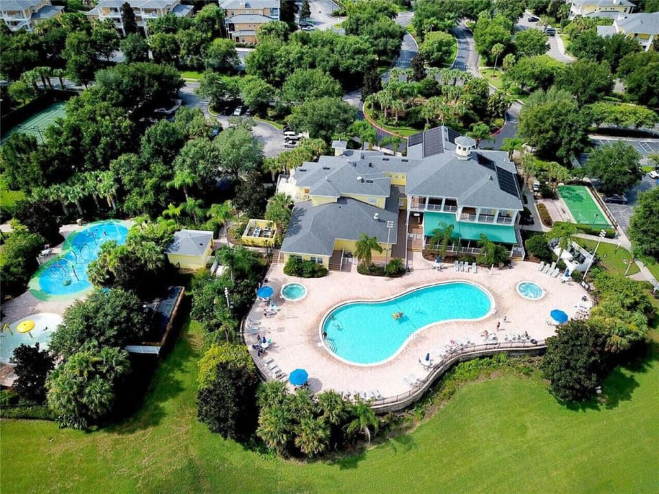 Resort-style pool with lounge chairs and sunny atmosphere