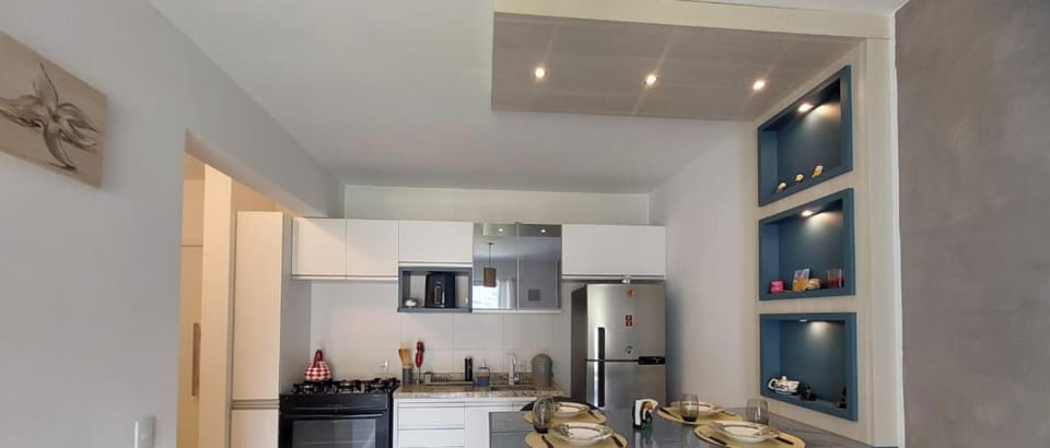 Deluxe Apartment | Private kitchen | Full-size fridge, microwave, cookware/dishes/utensils, dining tables