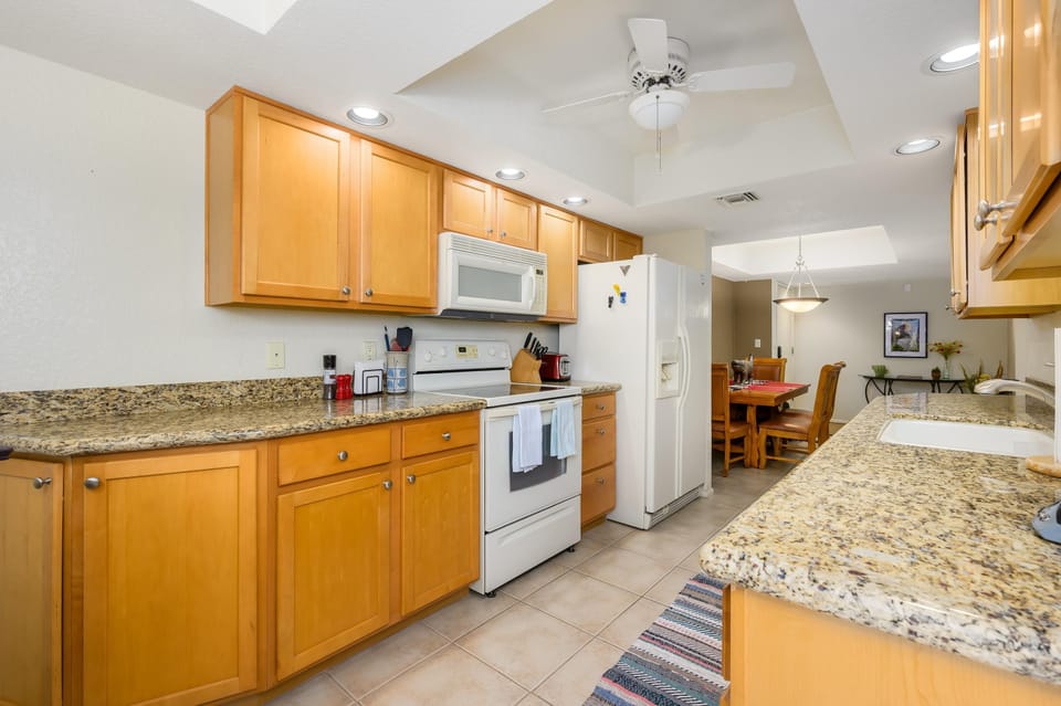 Bright, spacious kitchen with granite countertops and modern appliances