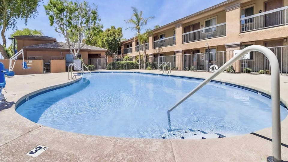Enjoy a refreshing swim in the inviting outdoor pool, perfect for a sunny day retreat.
