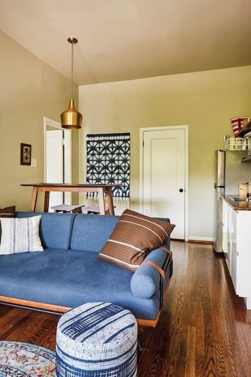 This modern one bedroom apartment stylishly contains everything a small family needs. The large bedroom offers a king size bed, and a daybed, as well as this daybed couch in the living room.