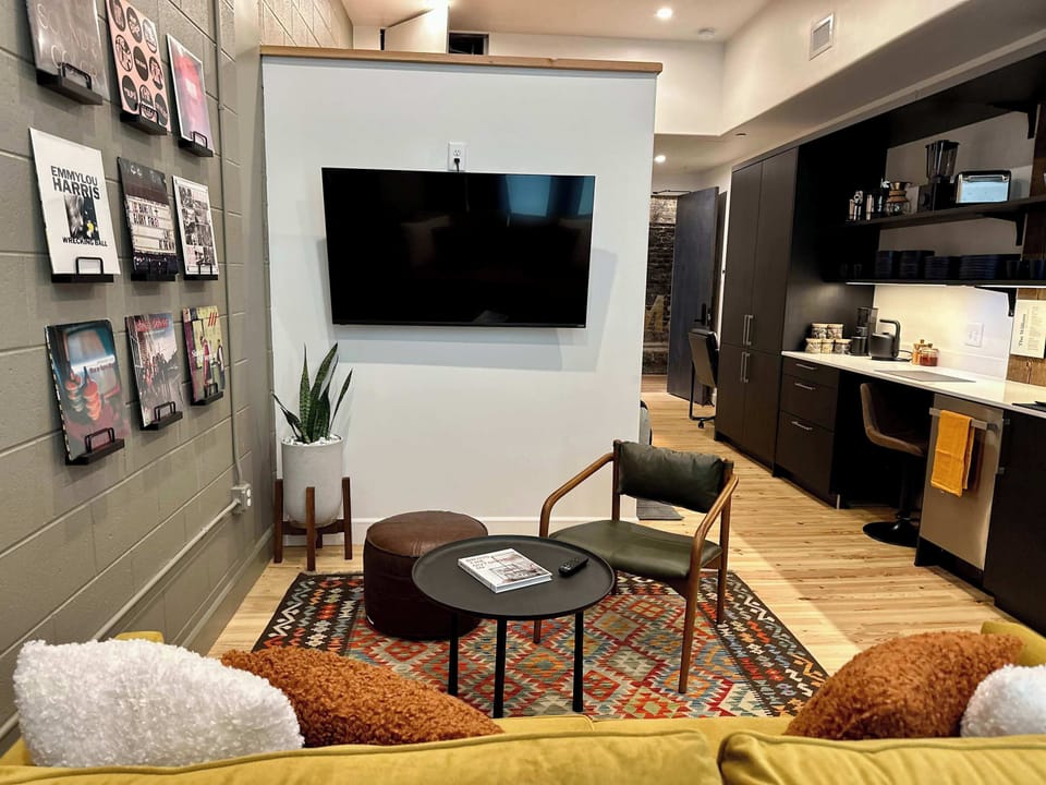 Stylish and comfortable, this open-concept living room blends historic character with modern comfort for the perfect city escape.