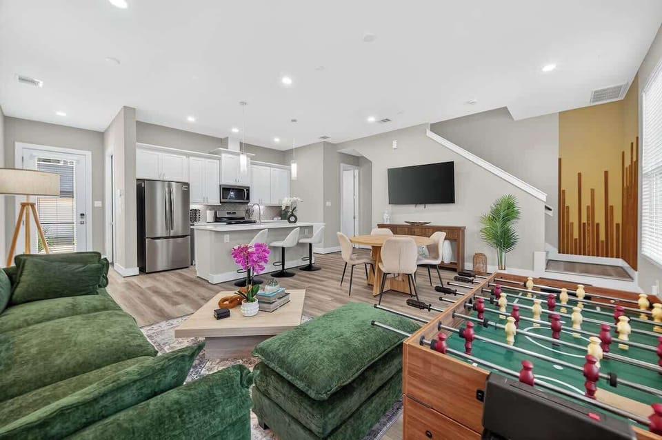 Living Room: Bright and spacious with a playful foosball table and stylish dining area!