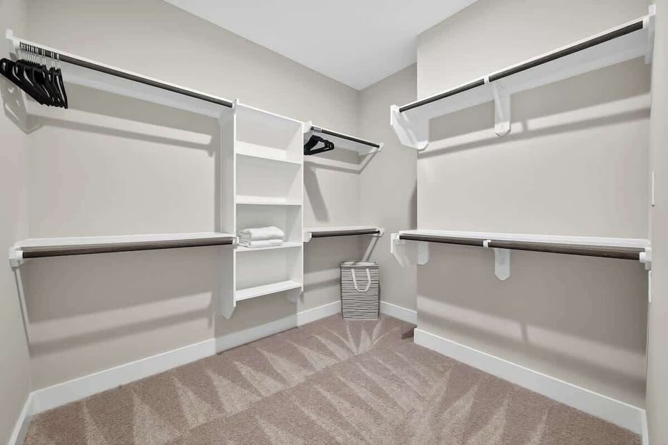 Walk-in Closet: Spacious storage solutions with stylish shelving for all your outfit needs!