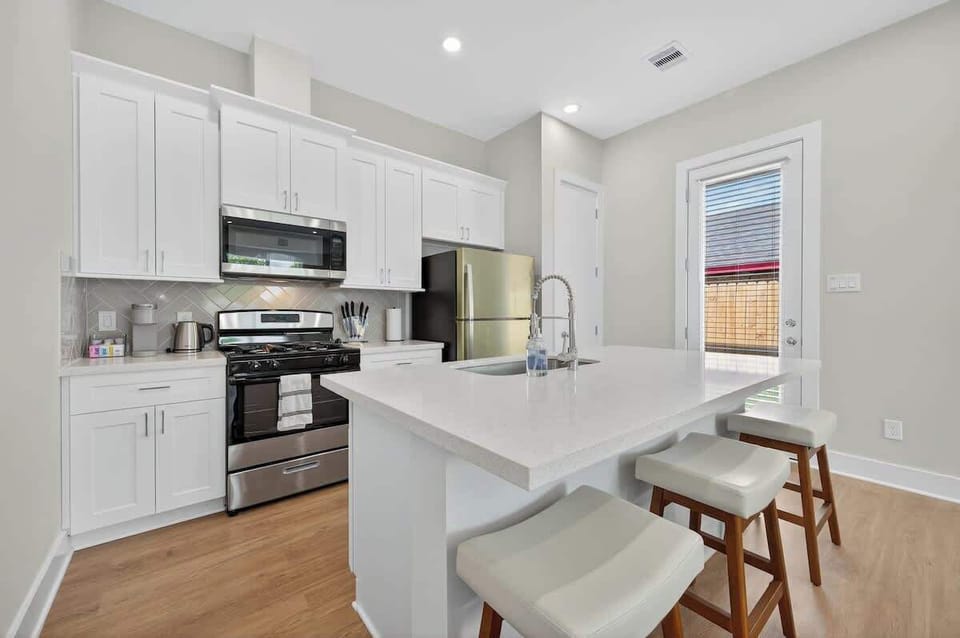 Fully equipped modern kitchen with island seating, perfect for cooking and gathering with friends or family.