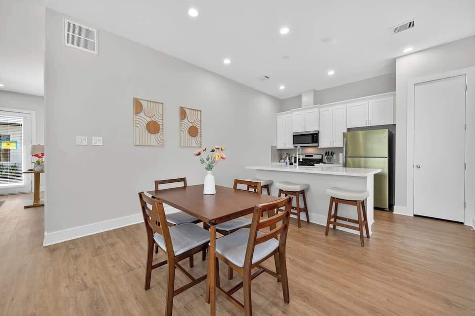 Modern dining space with seating for four, ideal for shared meals or remote work sessions.