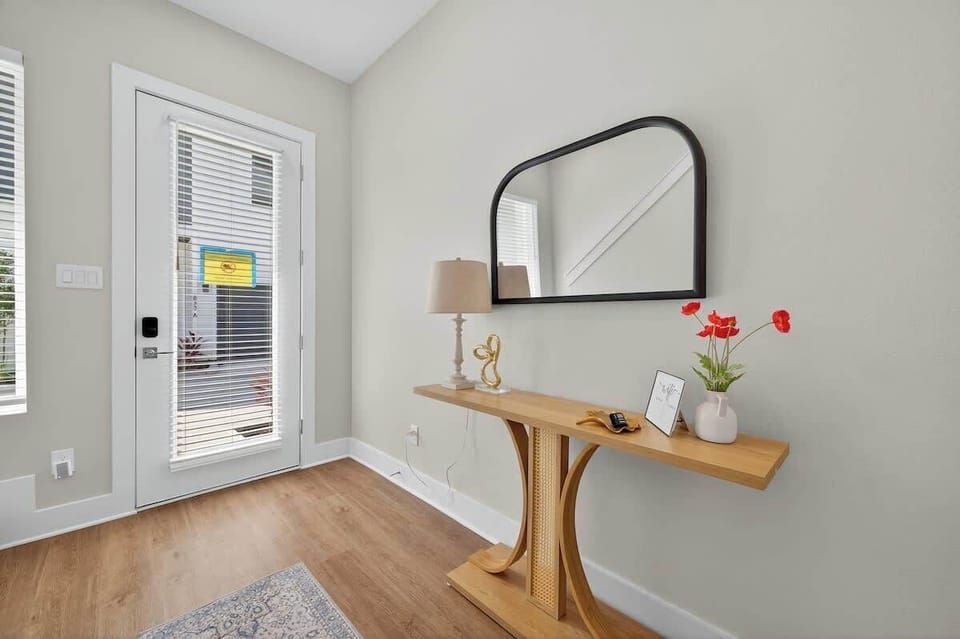 Inviting foyer with stylish decor and natural light to greet you as you arrive.