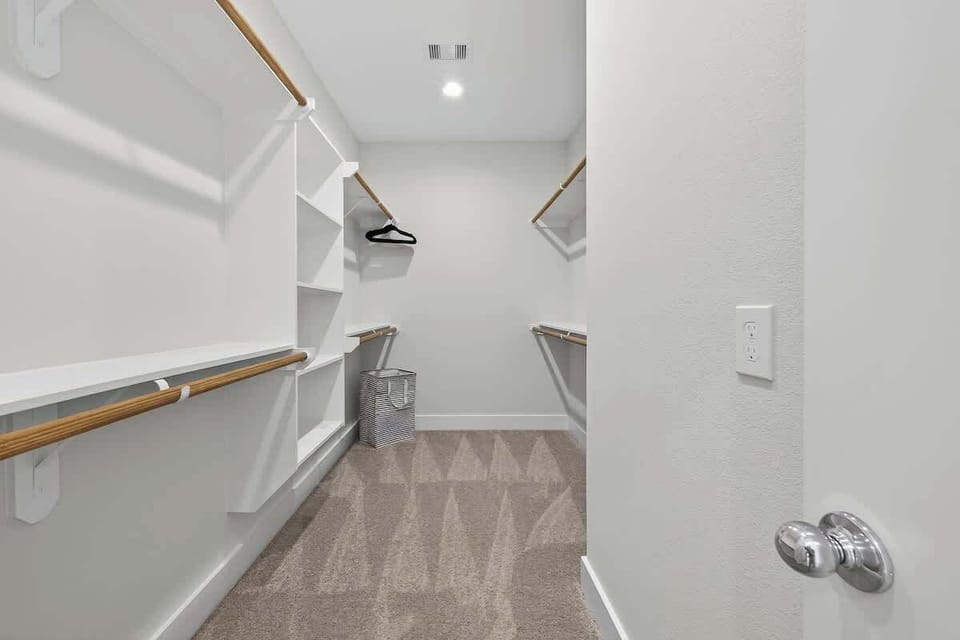 A spacious, custom-built walk-in closet provides extensive shelving and hanging space for long-term stays.
