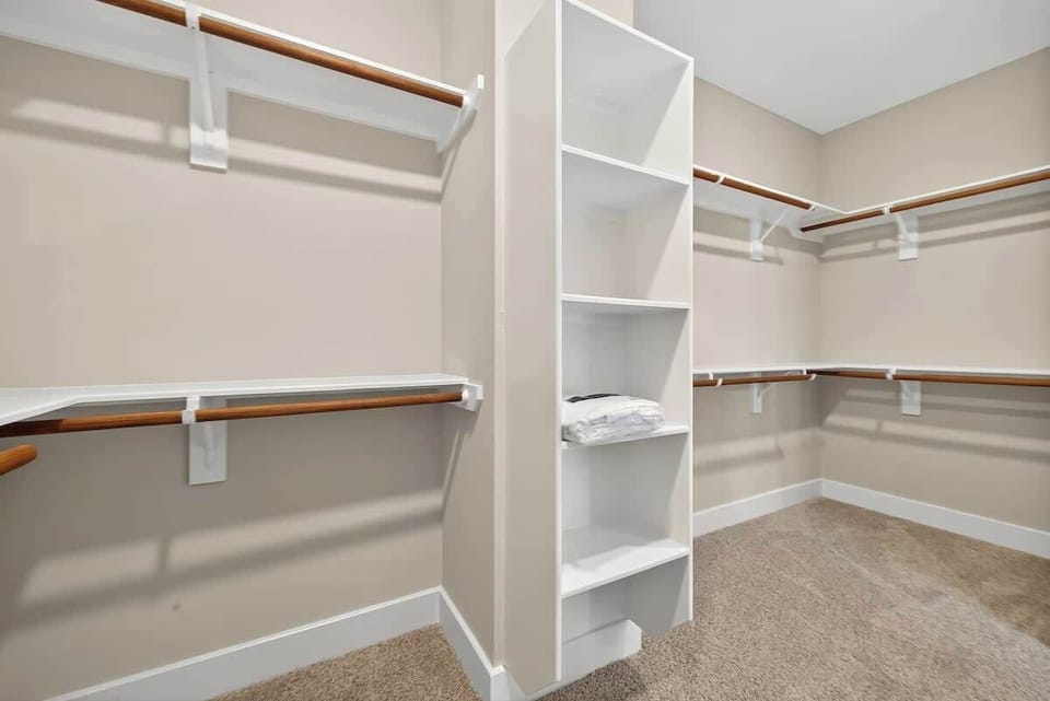 Walk-in Closet: Ample storage awaits with stylish shelving and organized hanging space!