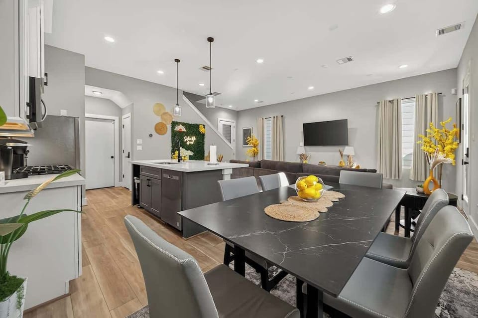Dining & Kitchen Oasis: Gather around the stylish black dining table with modern accents and vibrant decor!